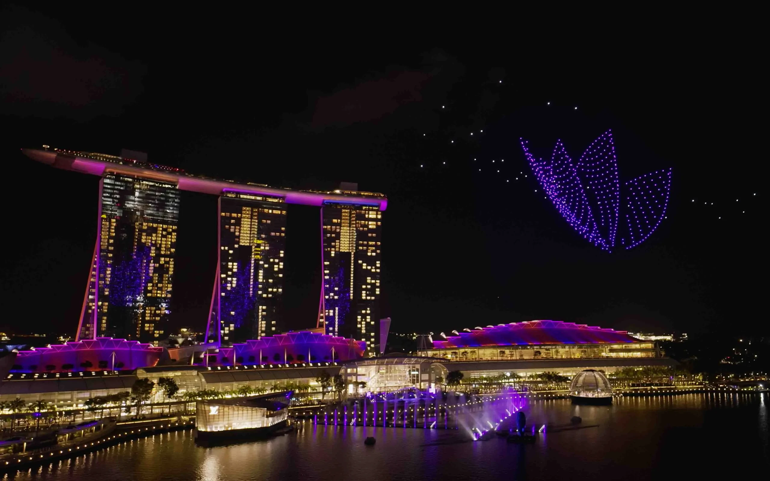 MIRS Drone Show performing iconic drone light show at Marina Bay Sands Singapore featuring a massive 3D geometric flower.