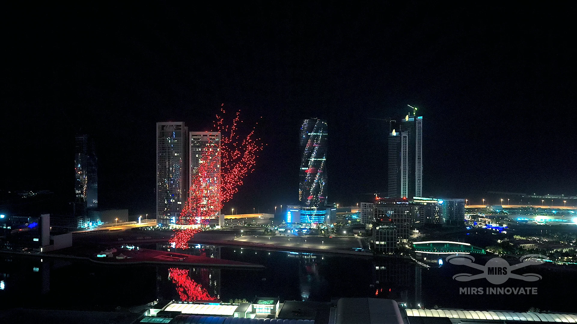 Aerial view of red drone formation launching over Manama skyline at Bahrain New Year 2026 drone show