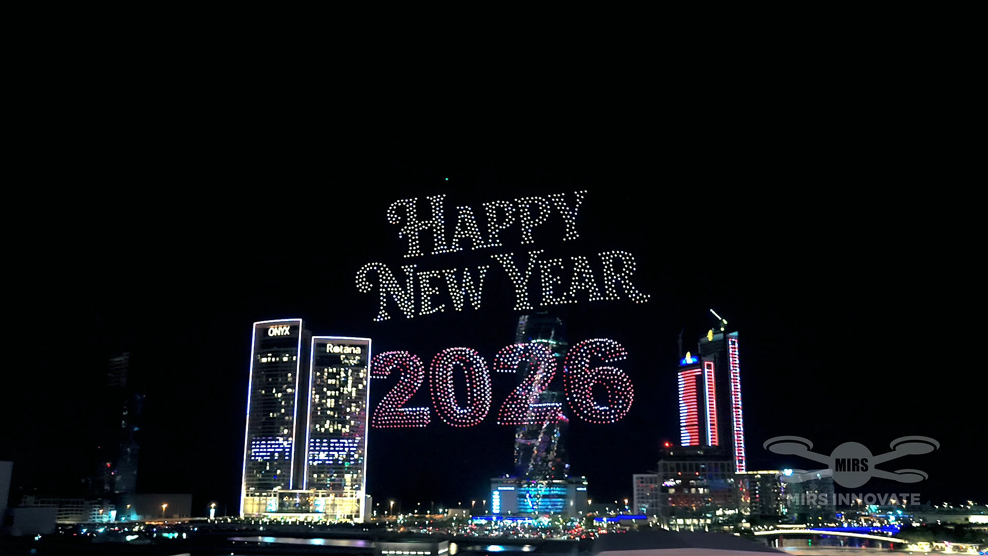 Happy New Year 2026 text drone formation over Bahrain Bay skyline drone light show