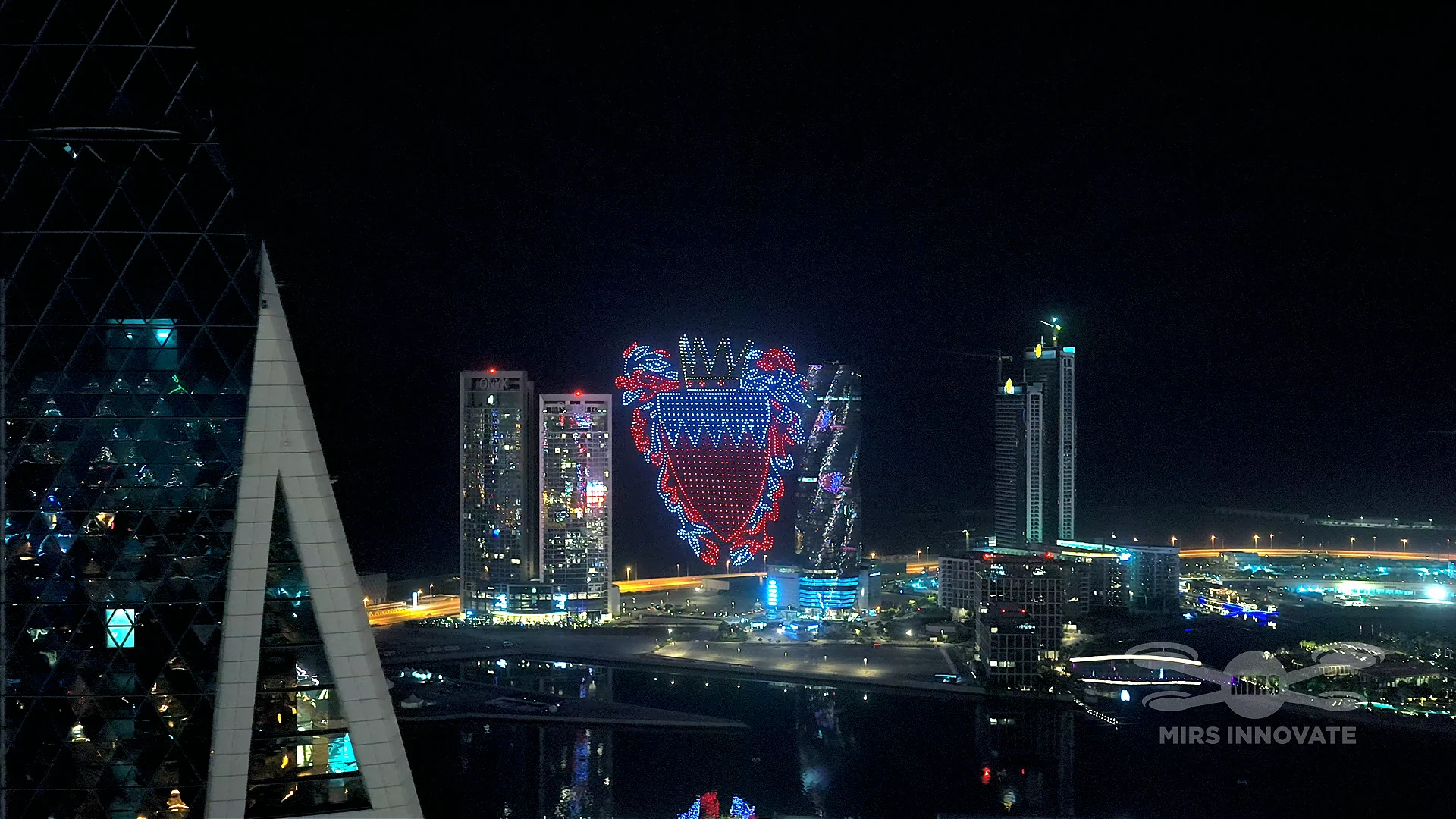 Bahrain national emblem coat of arms drone formation over Manama city skyline New Year 2026