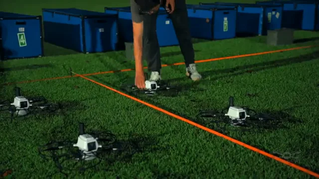 Drone fleet in grass landing zone after show — Socrates Social Apps drone light show post-flight, Sydney, Australia