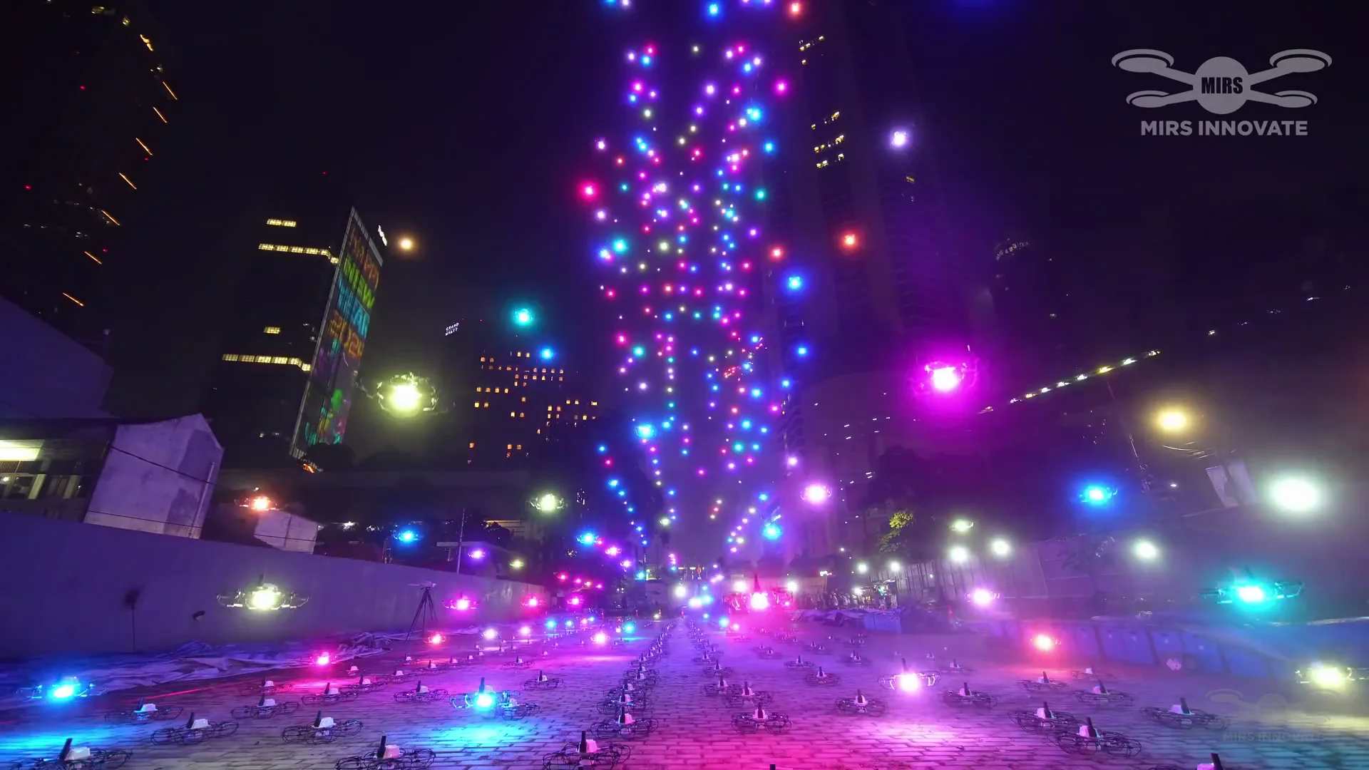 Colorful drone light burst formation during the launch sequence of the Jakarta New Year's Eve drone show at Bundaran HI — 500 drones
