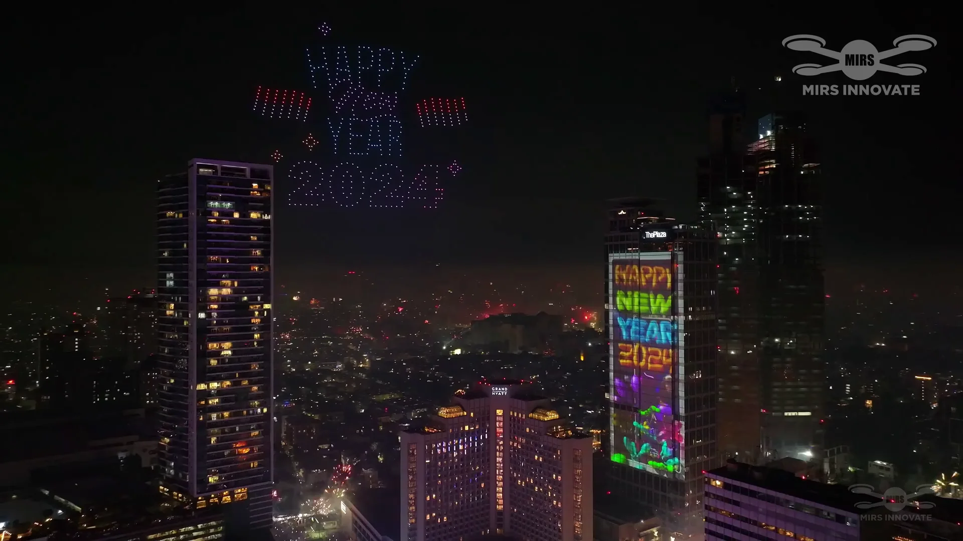 Jakarta cityscape drone light show formation above Bundaran HI during the New Year's Eve 2024 aerial celebration — 500 drones