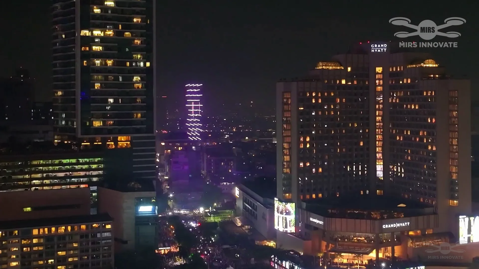 Night drone formation above the Jakarta skyline at the New Year's Eve drone light show — Bundaran HI, Indonesia — 500 drones