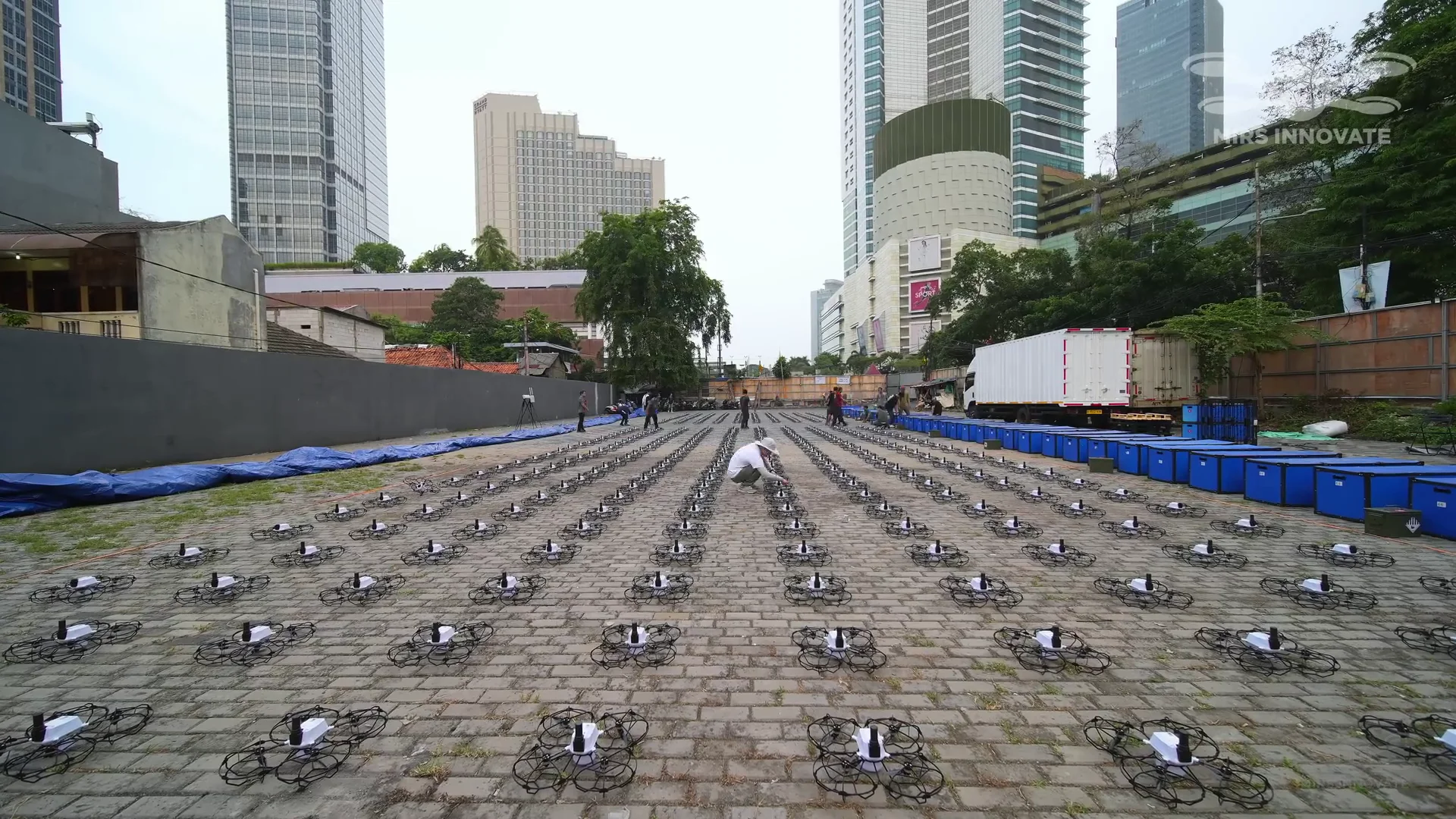 Wide rooftop drone staging grid setup before the Jakarta New Year's Eve drone show launch at Bundaran HI — 500 drones in formation