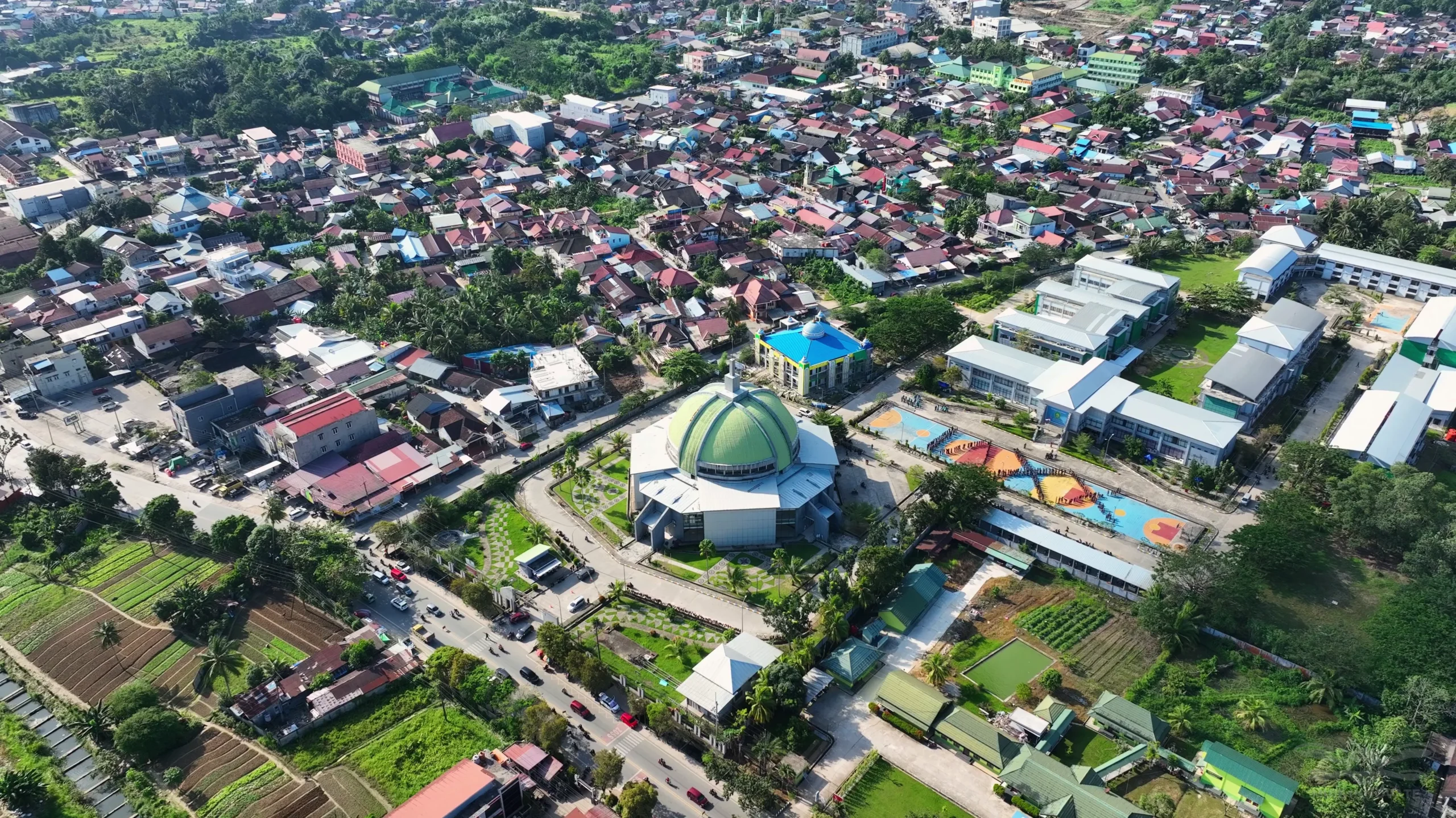 Aerial daytime view of Samarinda city and the MTQN XXX venue at Samarinda Stadium, East Kalimantan — before the 500-drone light show