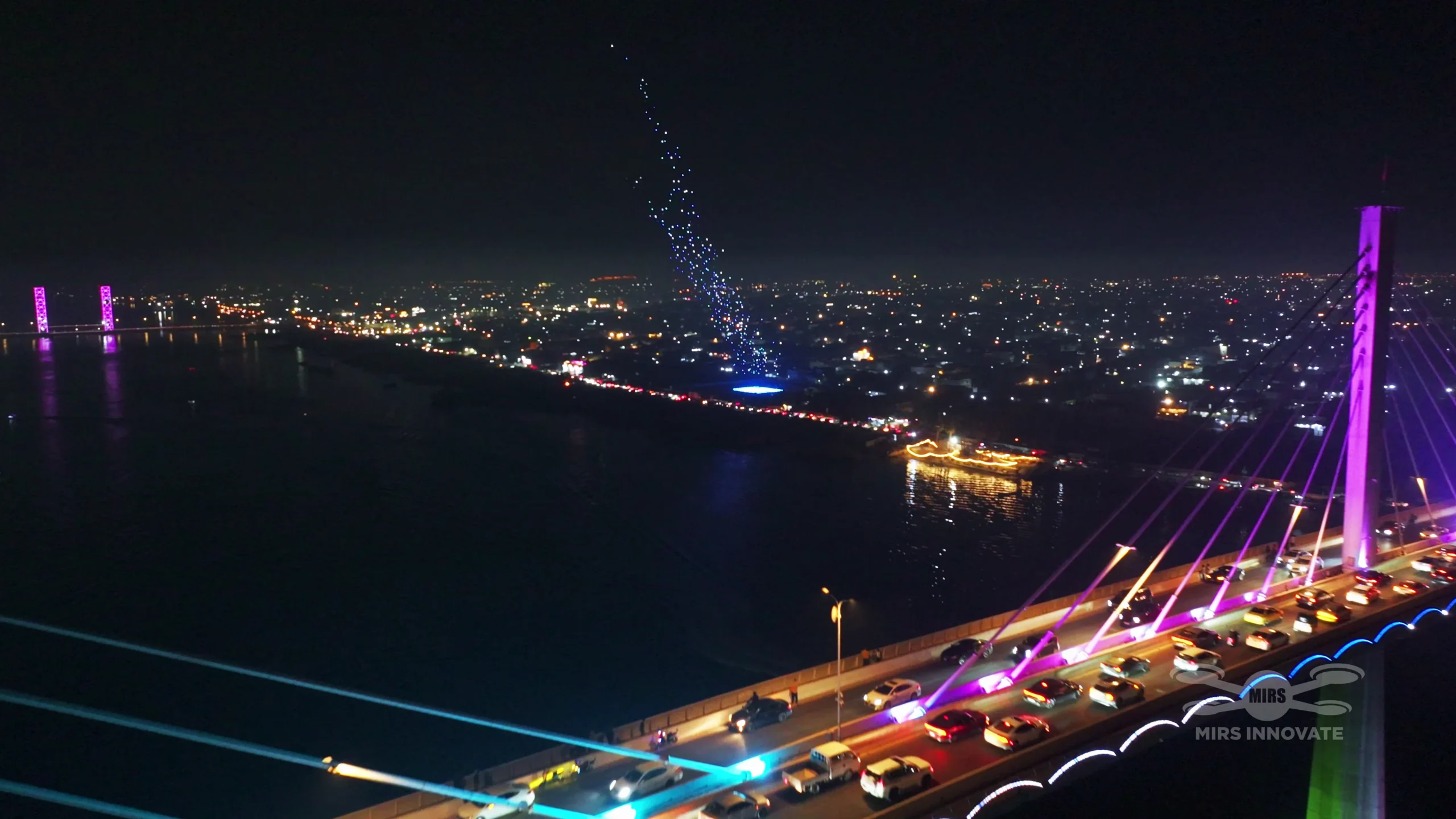 Aerial view of an illuminated bridge at a government celebration drone light show in Basra, Iraq — 2,000 drones