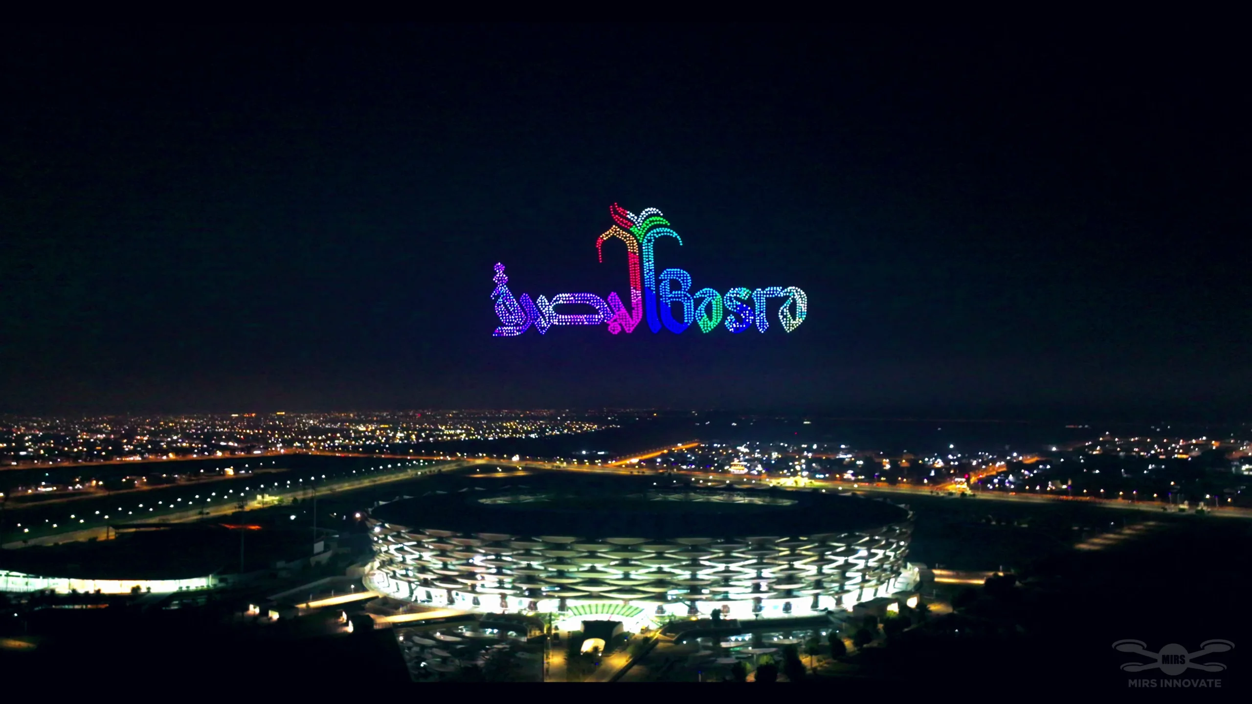 Basra city name text formation at a government celebration drone light show above Basra Stadium, Iraq — 2,000 drones