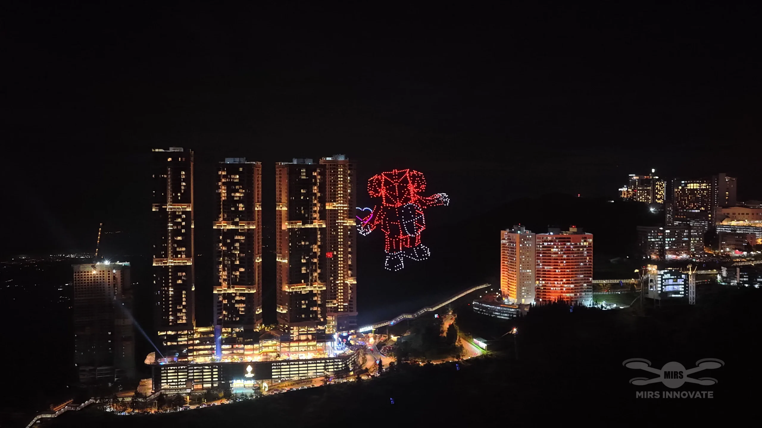 Robot character drone formation above the Genting Highlands cityscape, Malaysia