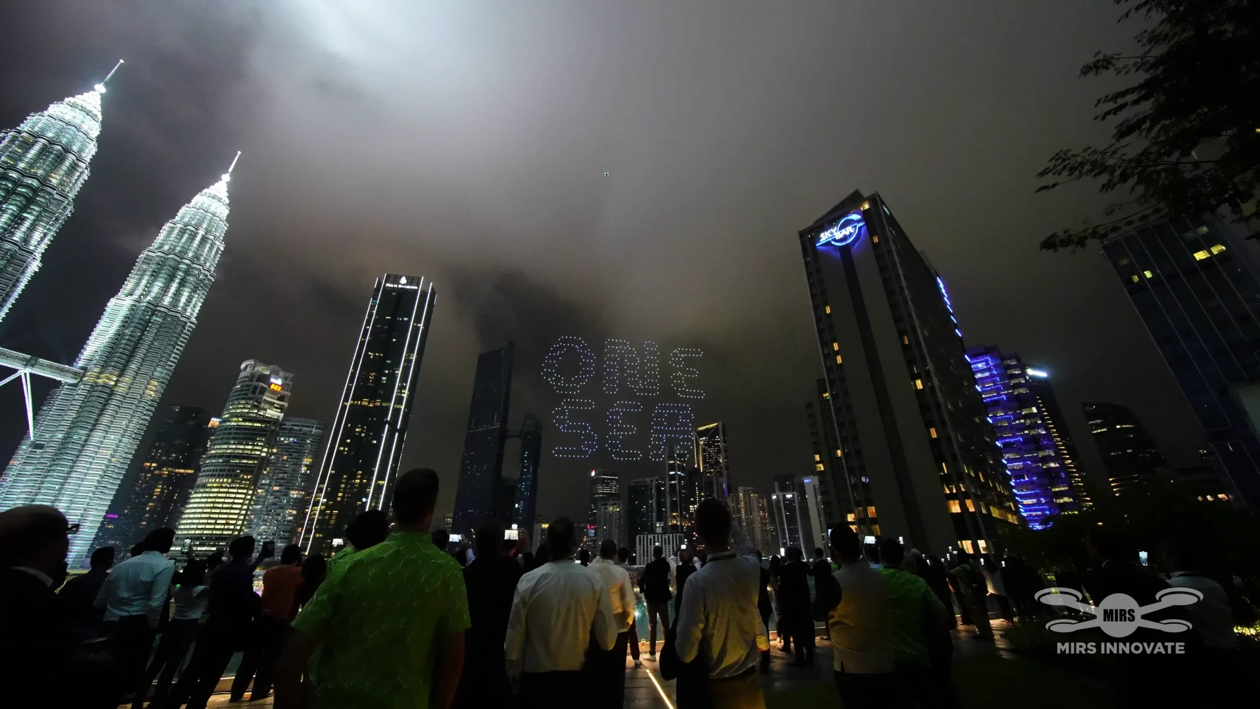 ONE FIRM drone text formation above Petronas Twin Towers for Deloitte 25th anniversary Kuala Lumpur