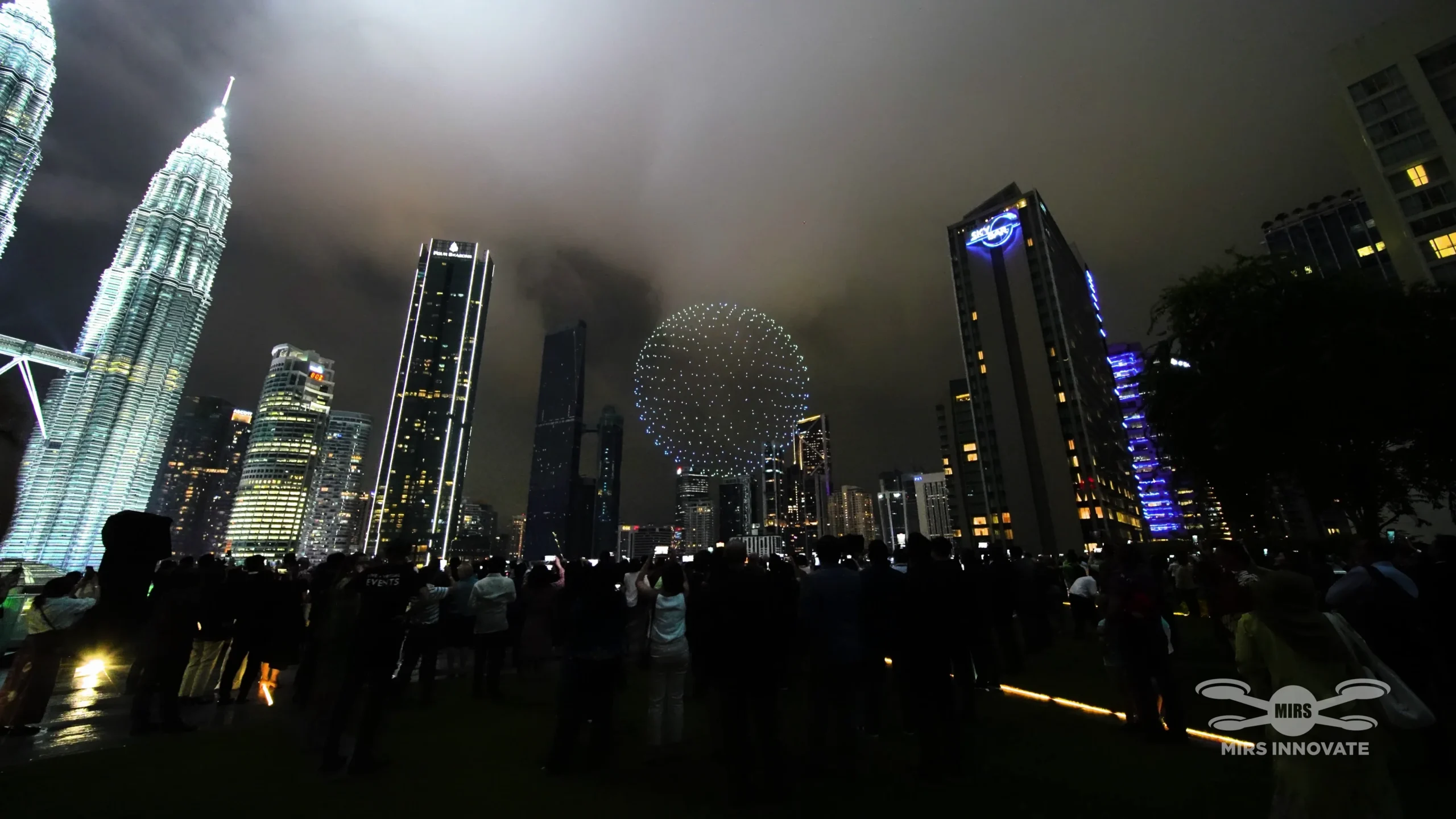 500-drone sphere formation above crowd with Petronas Twin Towers Kuala Lumpur