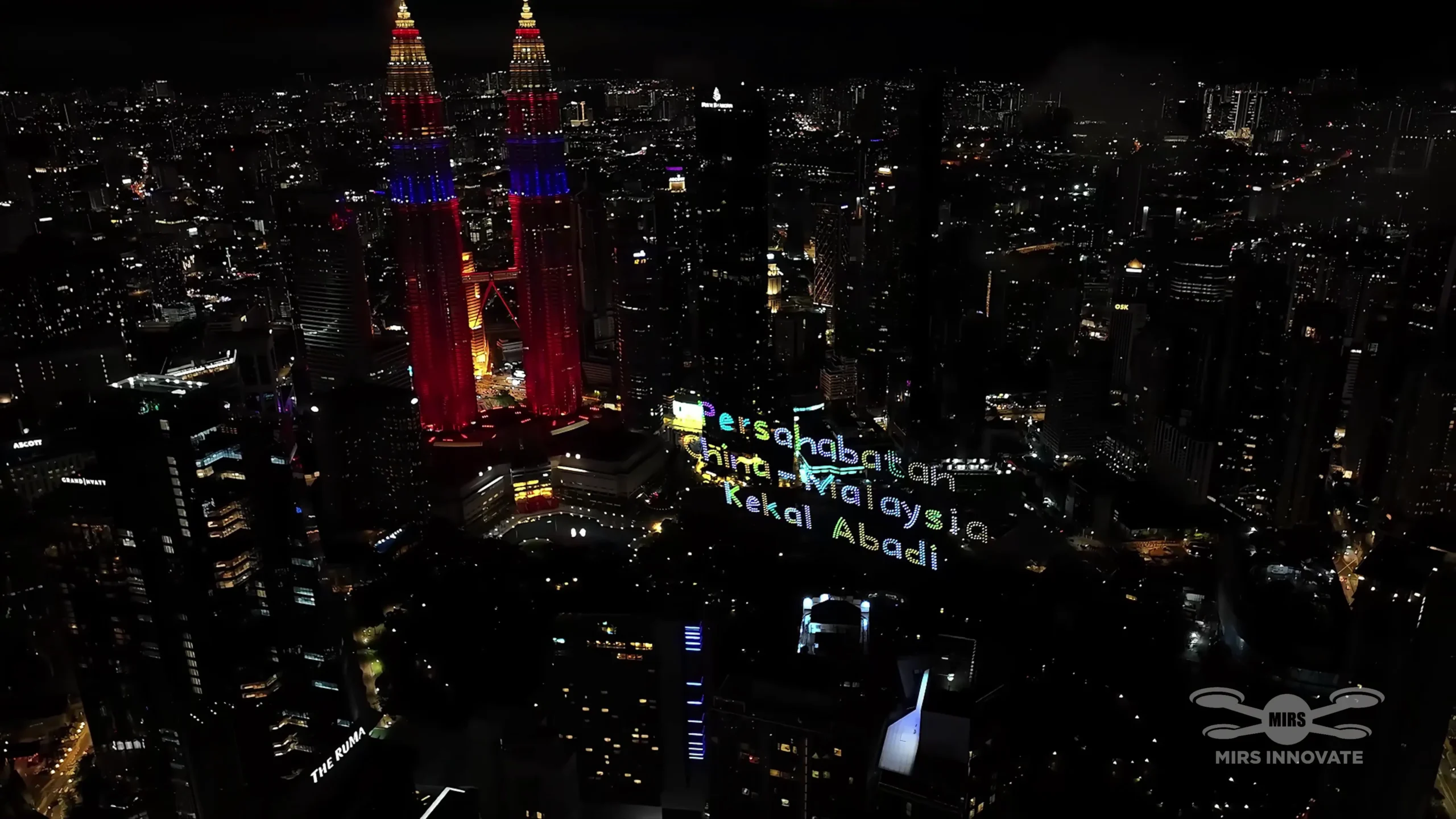 Persahabatan China Malaysia Kekal Abadi text formation beside Petronas Twin Towers in Kuala Lumpur