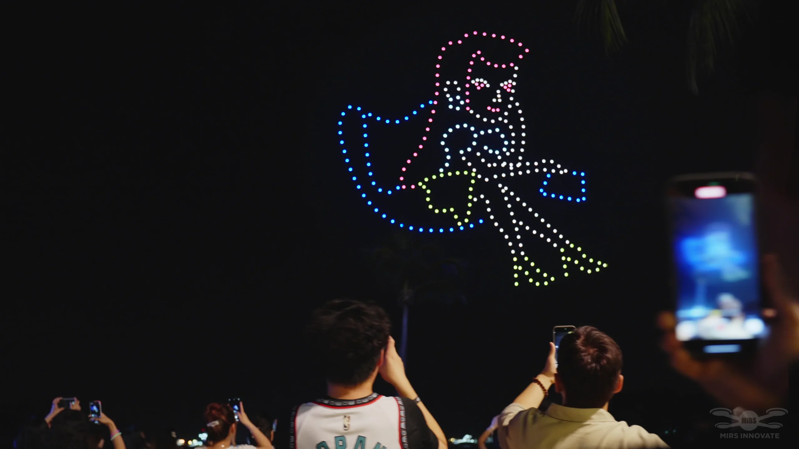 Dancer figure formation above the YuanYi 2025 audience at Siloso Beach Sentosa