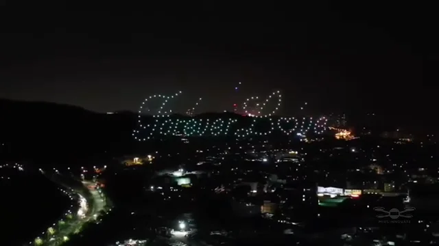 I Love You text formed by 250 drones above a cityscape