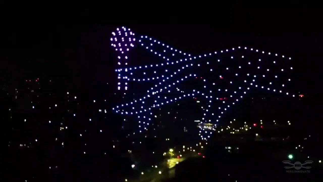 Winged figure created with drones above the city