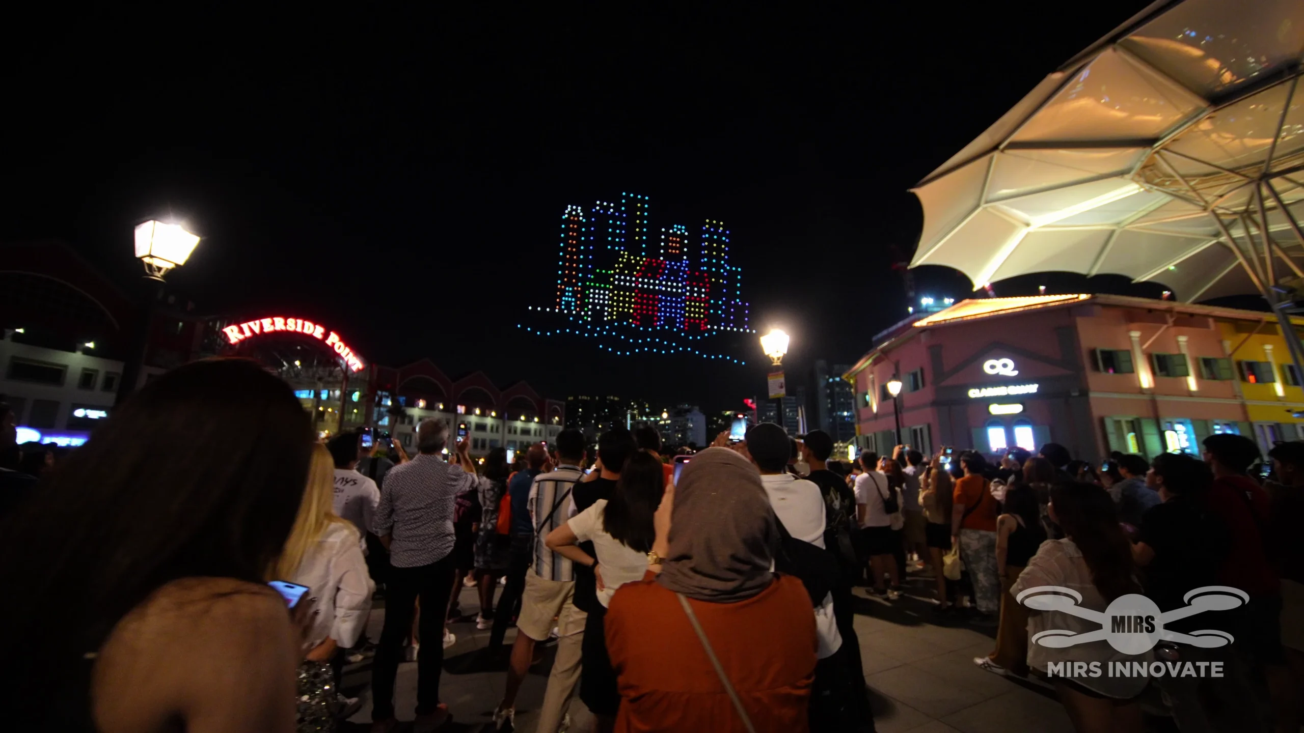 Audience watching cityscape drone formation at Clarke Quay Singapore Chinese New Year Eve