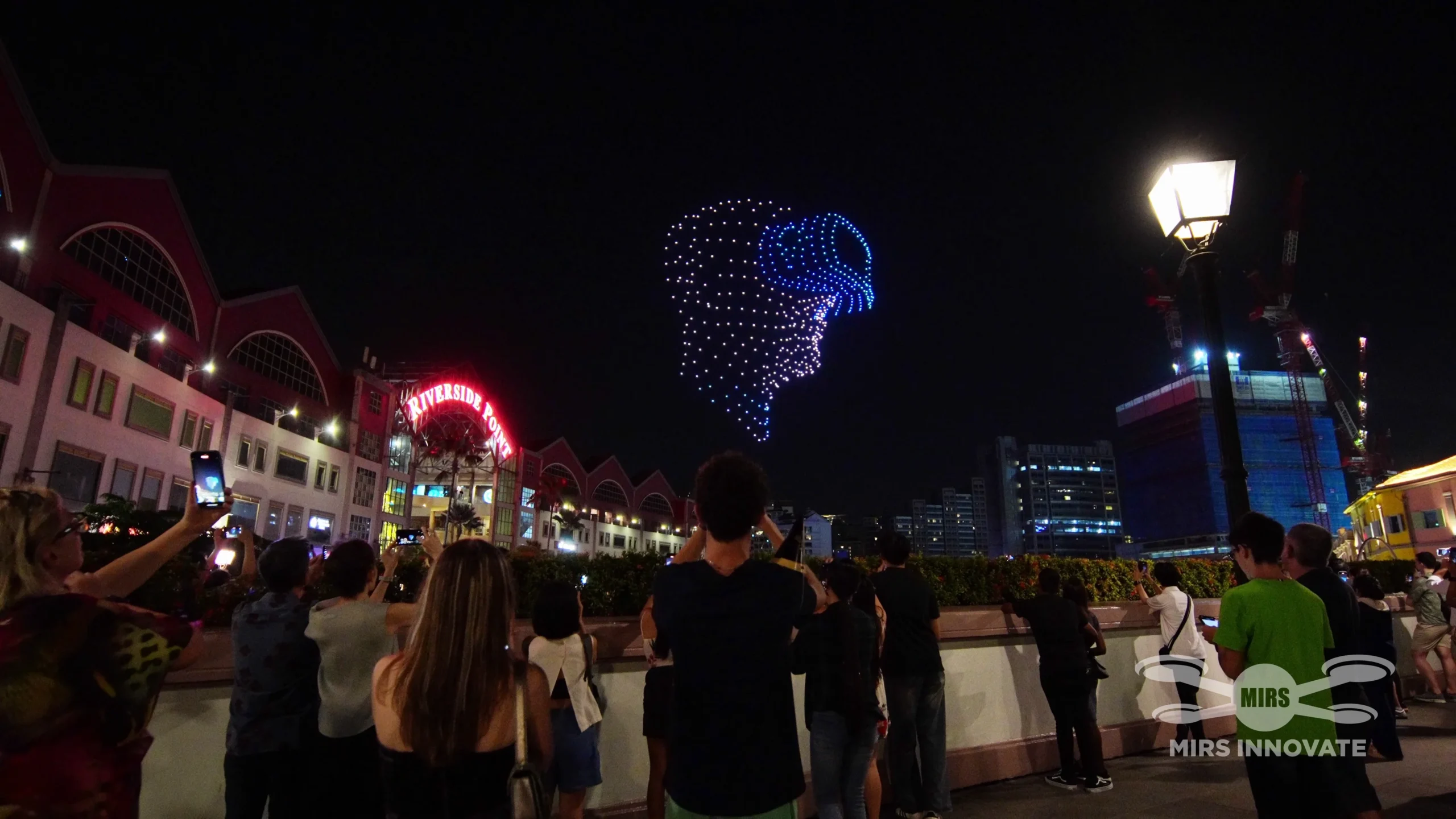 Audience watching lion head drone formation at CQ Chinese New Year Eve drone show in Singapore