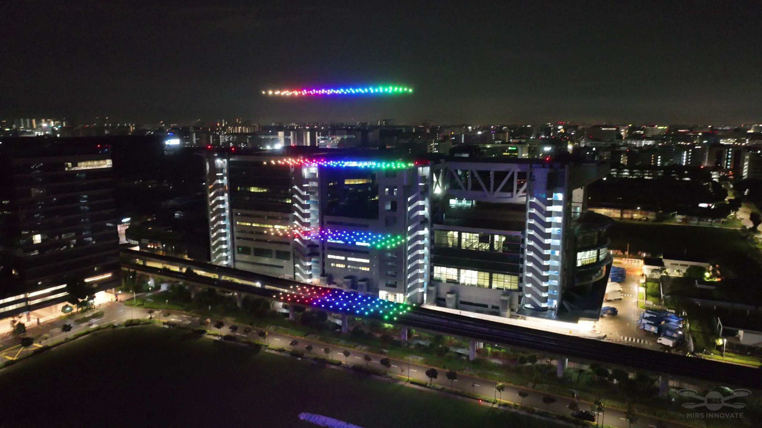 Rainbow drone grid above the Geylang Serai building during Bazaar Raya