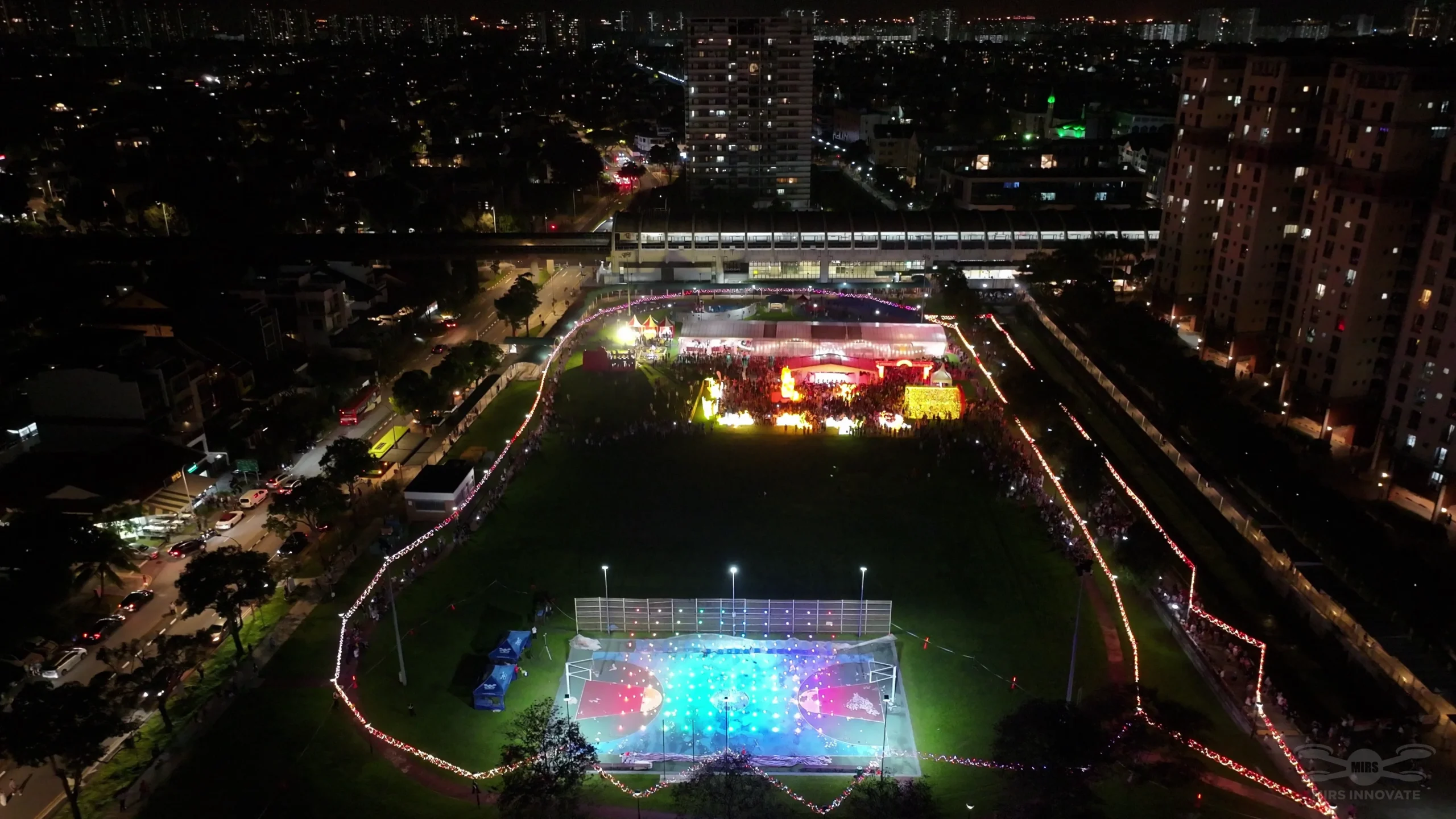 Wide aerial view of the Kampong Kembangan CC drone show in Singapore
