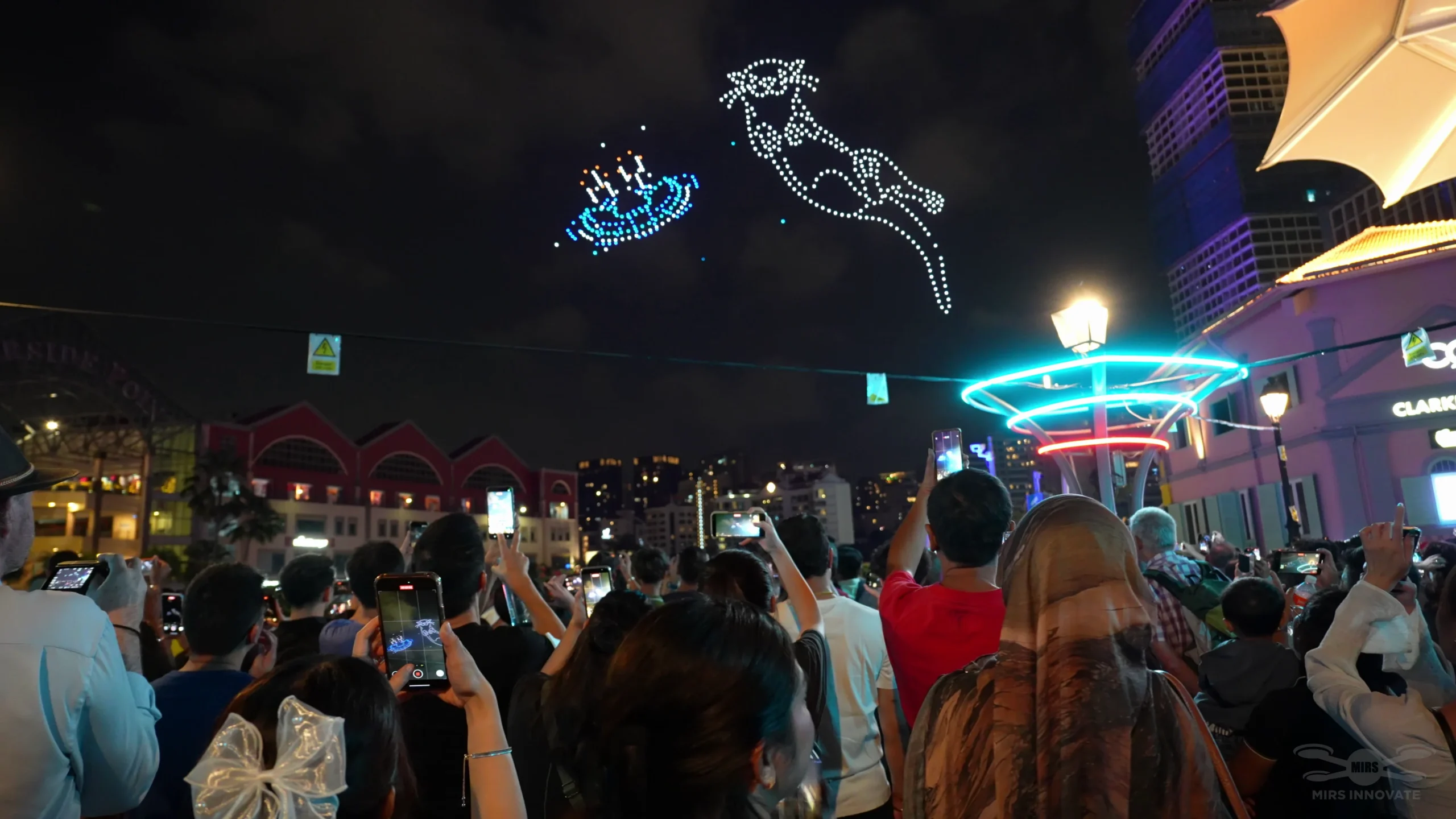 Audience watching character drone formation at Singapore New Year Eve celebration