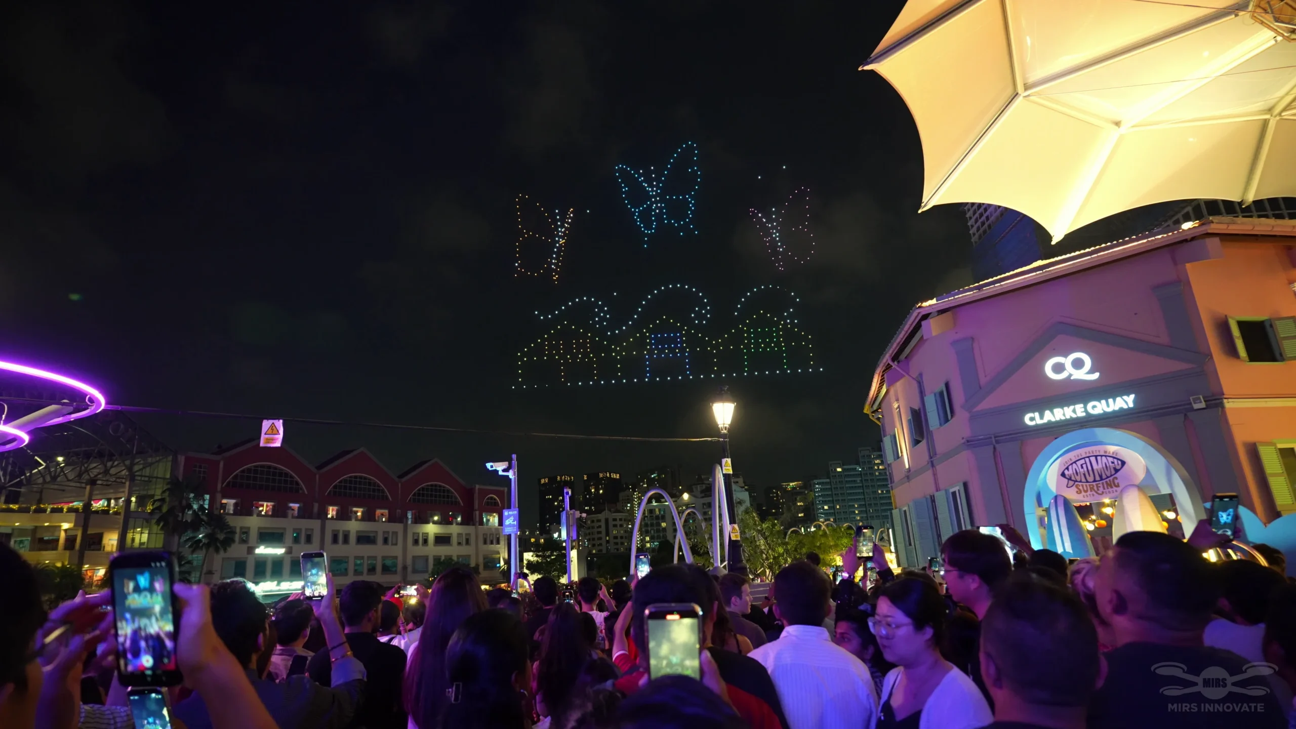 Butterfly and rooftop drone formation viewed by crowd at Singapore New Year Eve
