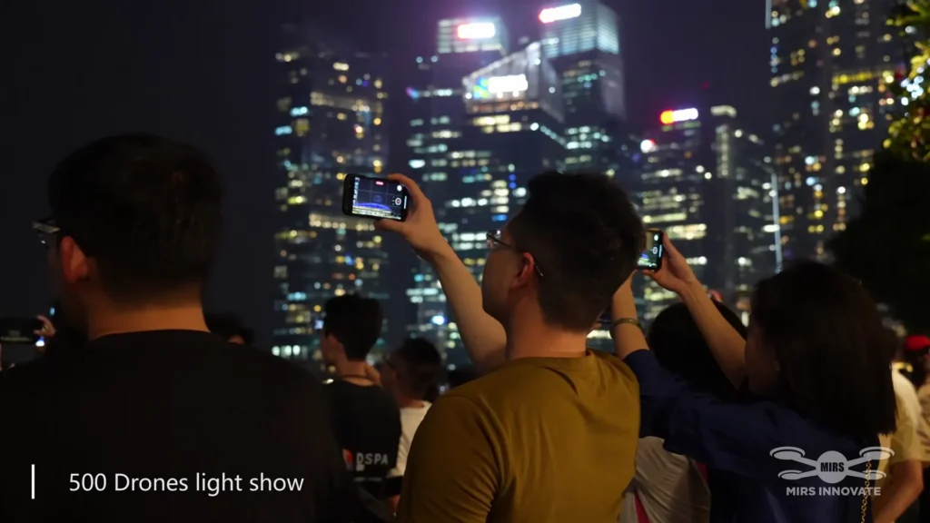 Audience recording a MIRS drone light show at a Singapore technology event