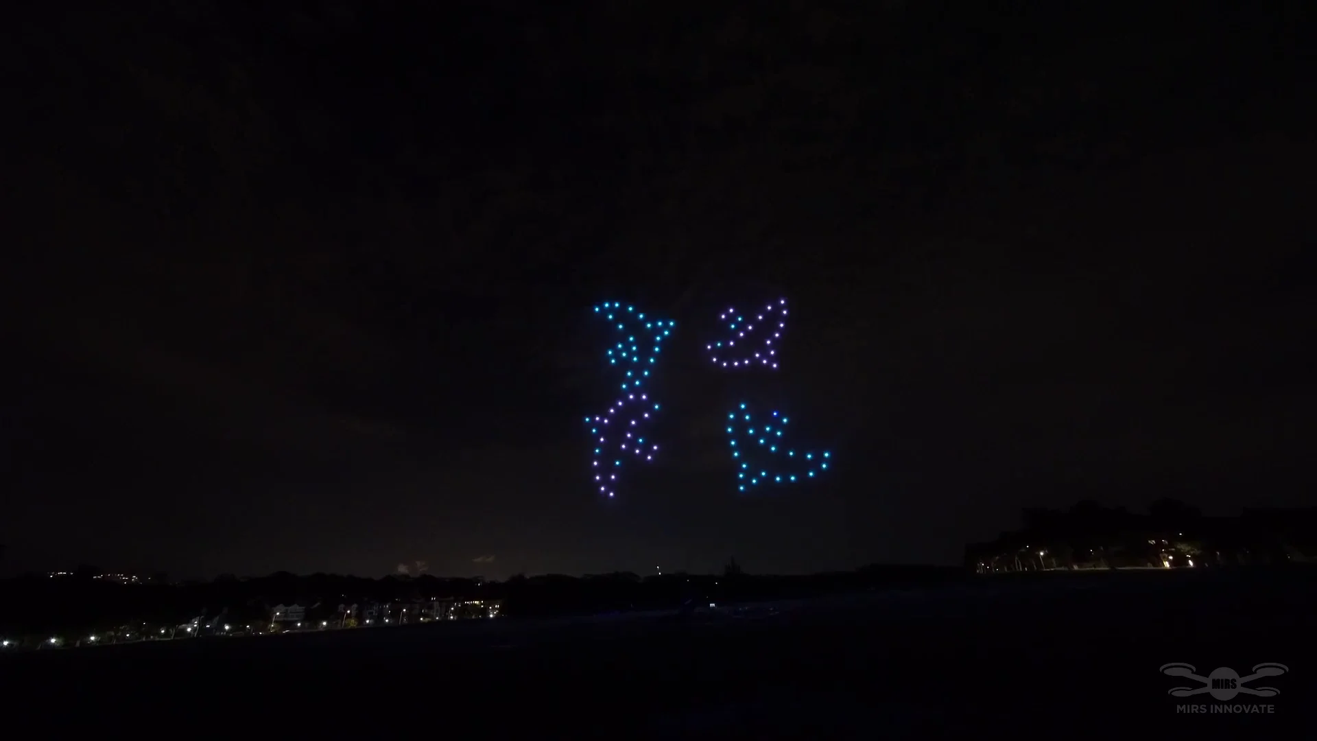 Blue and purple couple silhouette drone formation for a Sentosa proposal