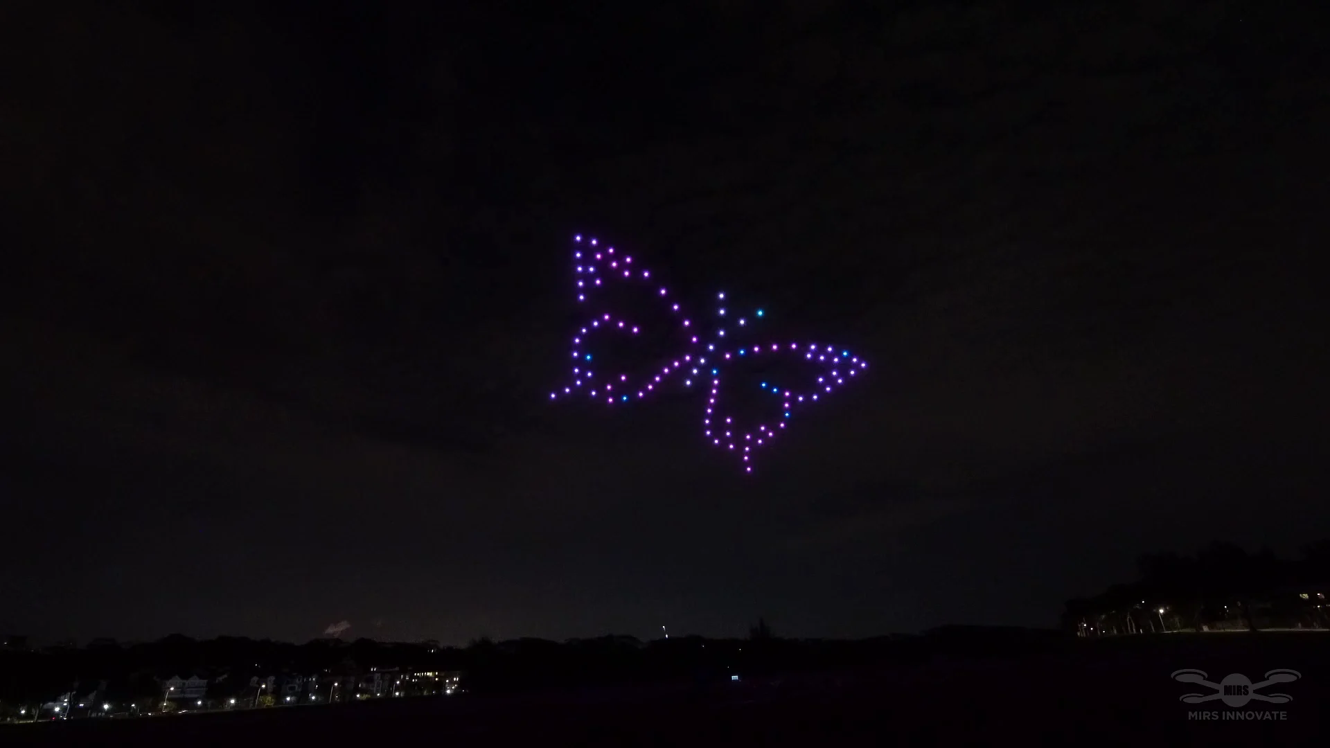 Purple butterfly drone formation closing a Singapore wedding proposal show