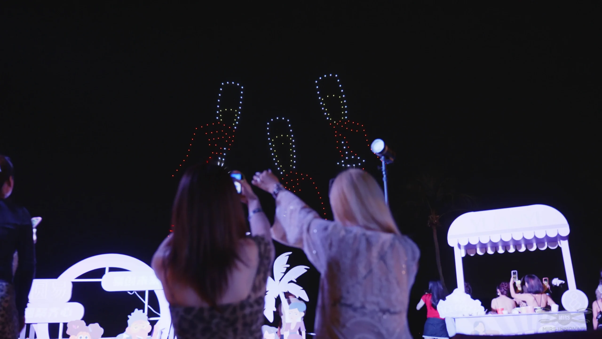 Audience watching a red figure formation during the YuanYi 2025 drone show Singapore