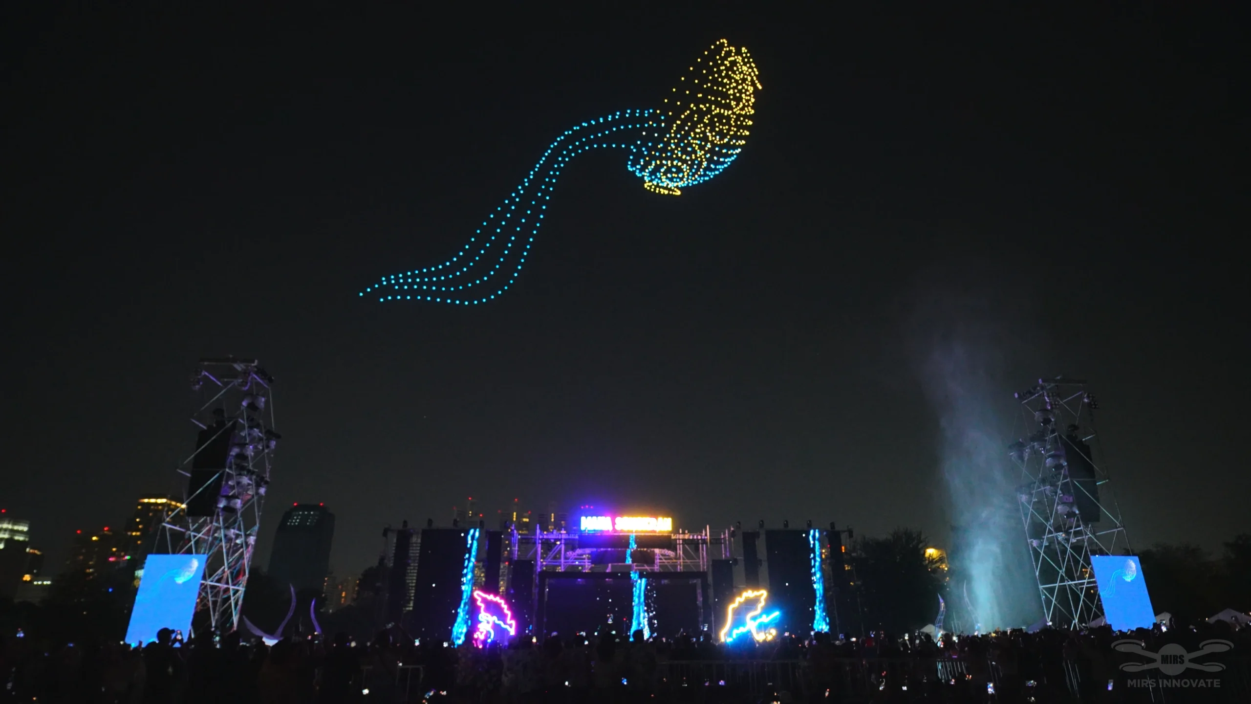 Feather-shaped light formation above a Thailand festival stage