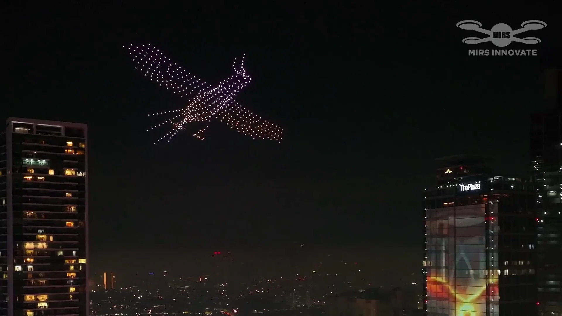Bird formation above the Jakarta skyline at the Bundaran HI New Year's Eve drone light show in Indonesia