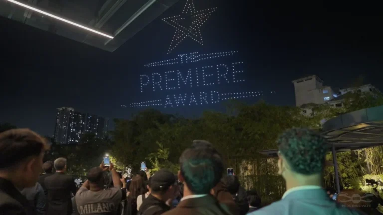 Guests watching a star drone formation at an outdoor Kuala Lumpur corporate event