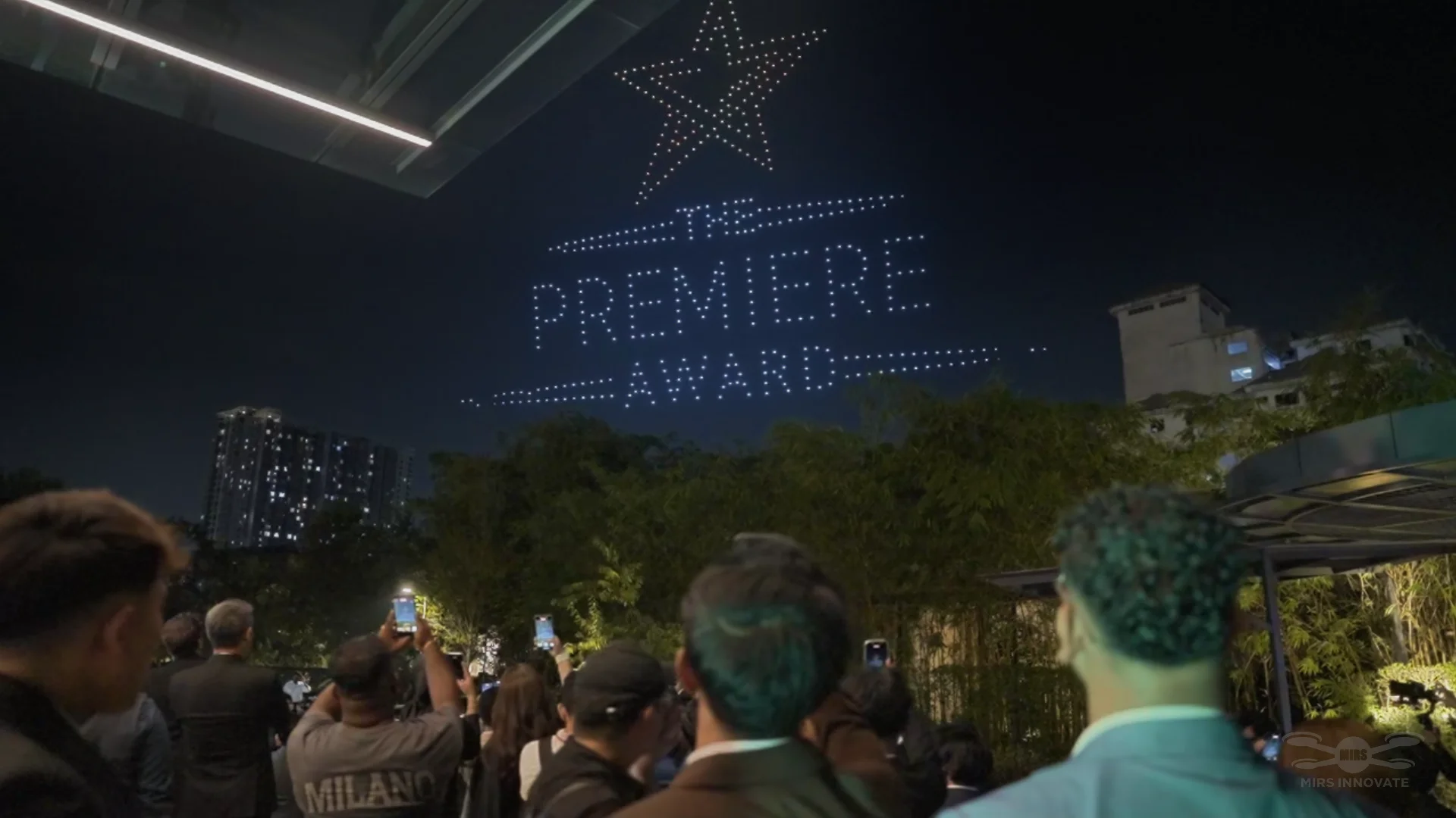 Guests watching a star drone formation at an outdoor Kuala Lumpur corporate event