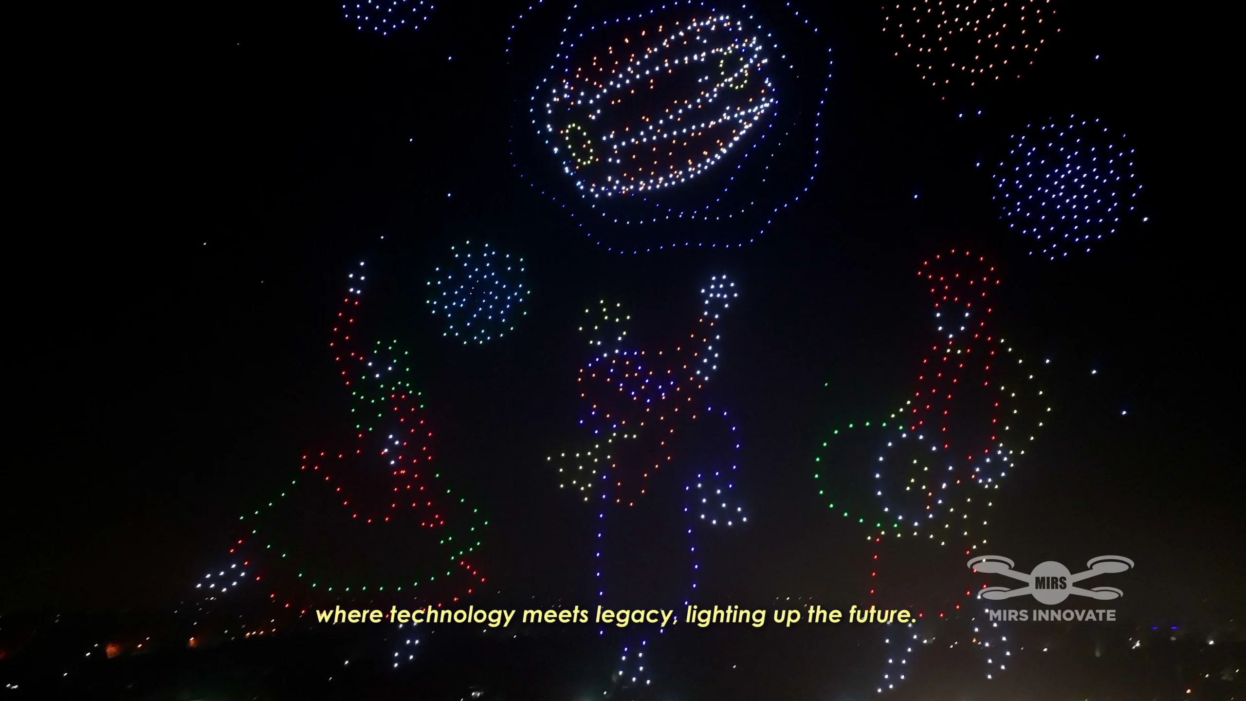 Three people dancing and playing instruments beneath fireworks at the Lahore closing drone show in Pakistan