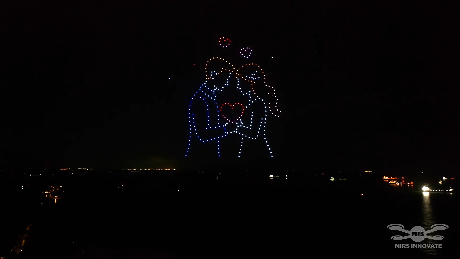 A Promise for Forever couple holding a heart formation in a 300-drone family celebration at Sentosa
