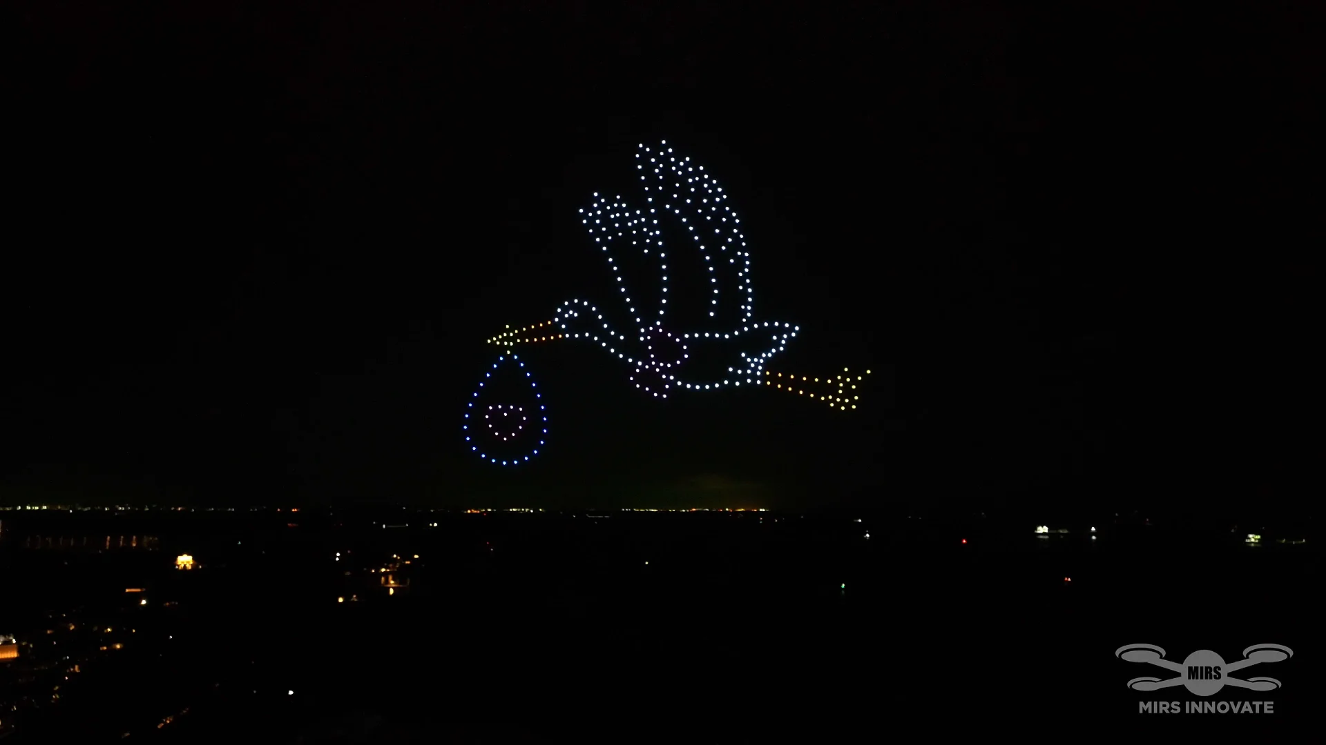 A Blessing on the Way stork carrying a baby formation in a private family drone light show