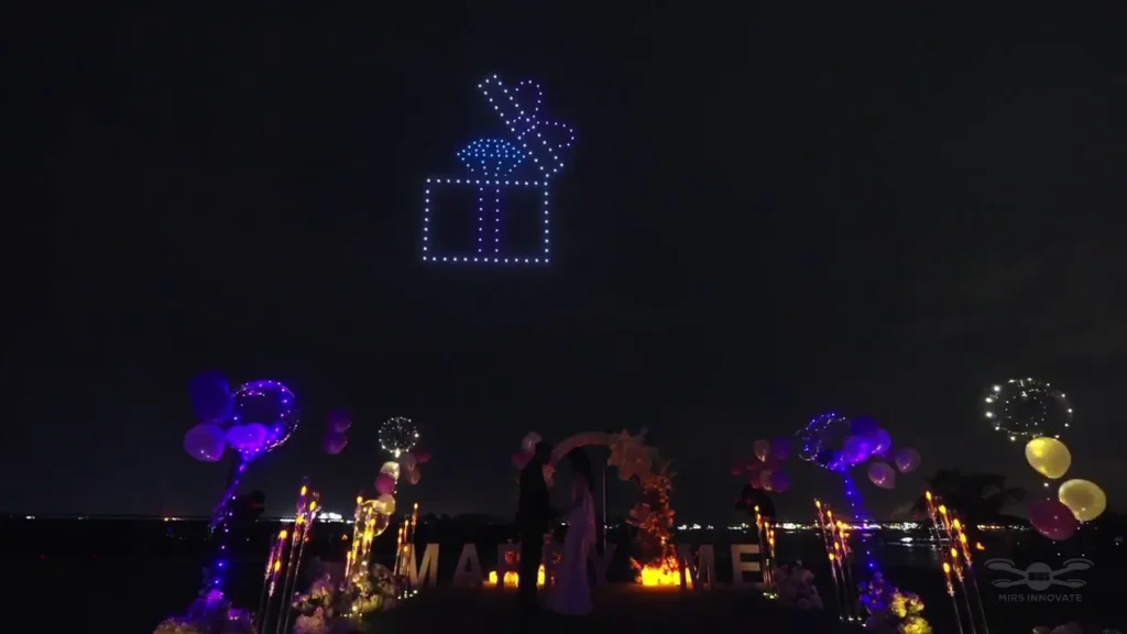Gift box and heart drone formation above a decorated wedding proposal venue in Sentosa, Singapore