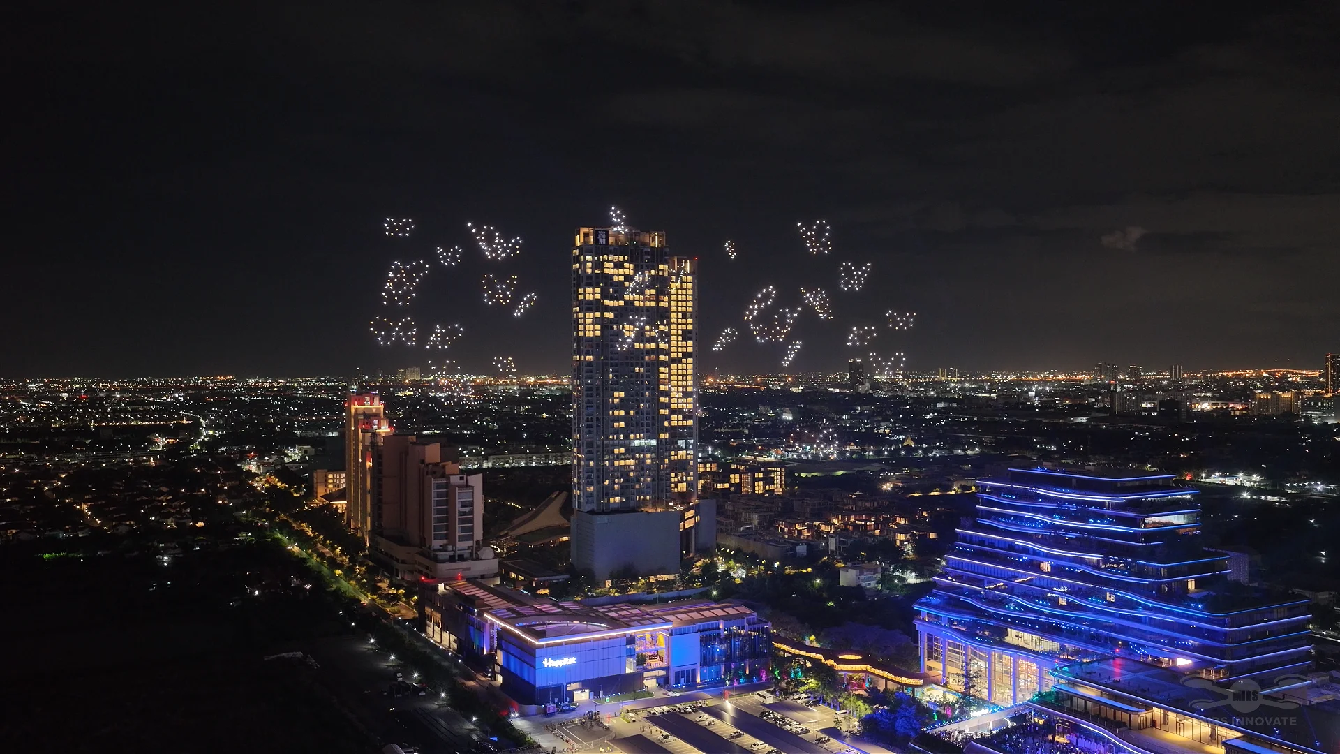 Butterfly swarm drone formation above the Bangkok skyline for Happitat