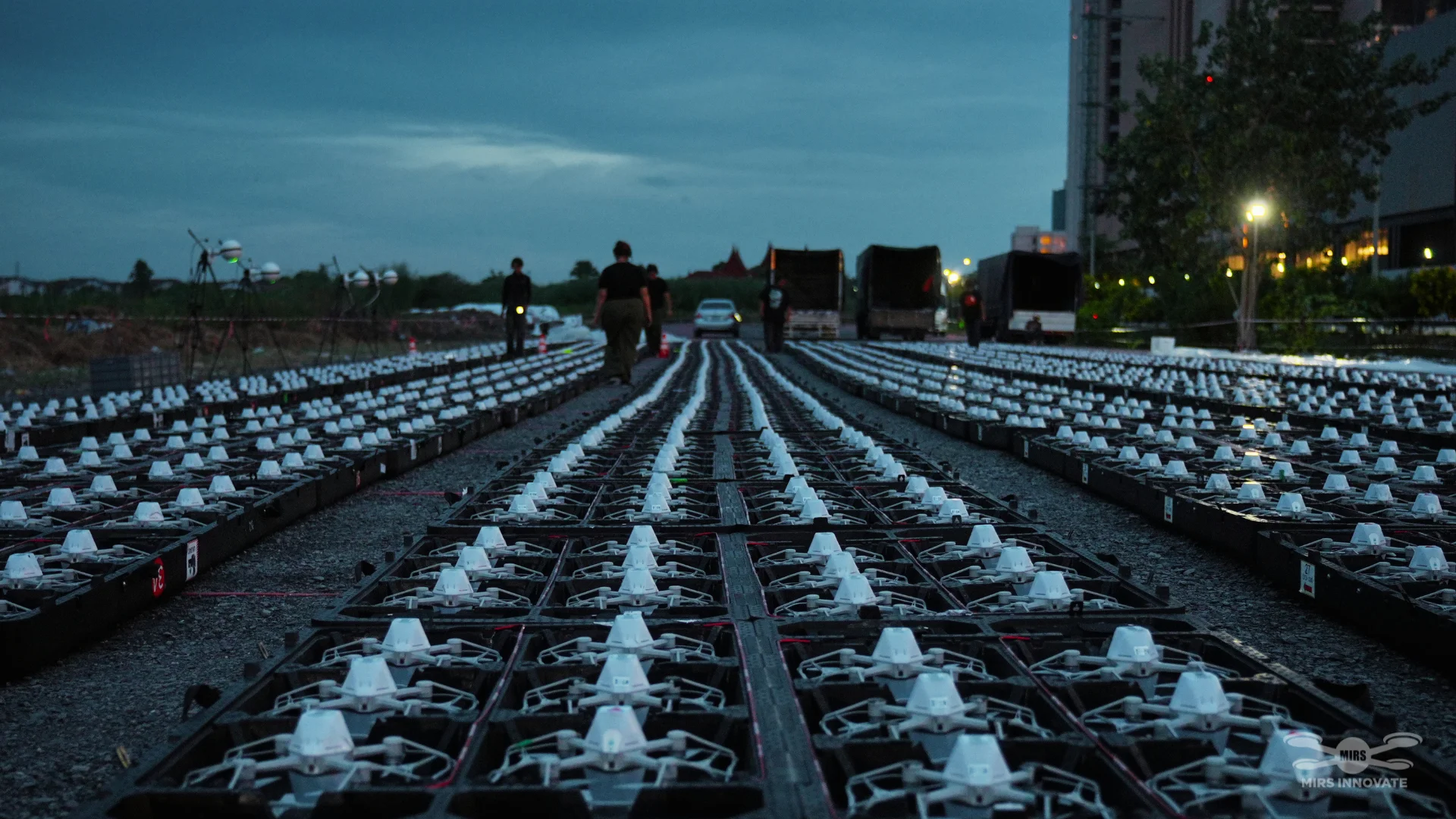 Rows of drones prepared at twilight for the Happitat Grand Opening show