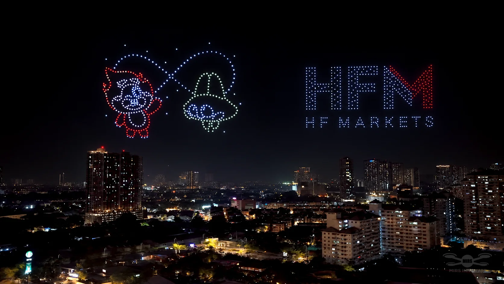 HFM logo with Solar and Luna drone formations over the Kuala Lumpur skyline