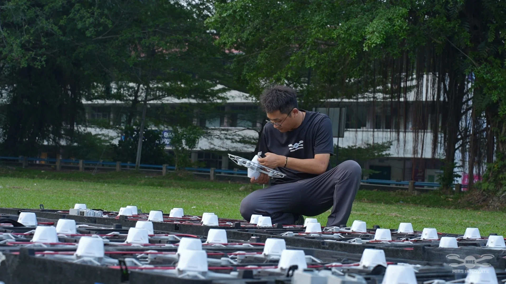 MIRS team member inspecting a drone during fleet preparation for the JPJ NPI launch